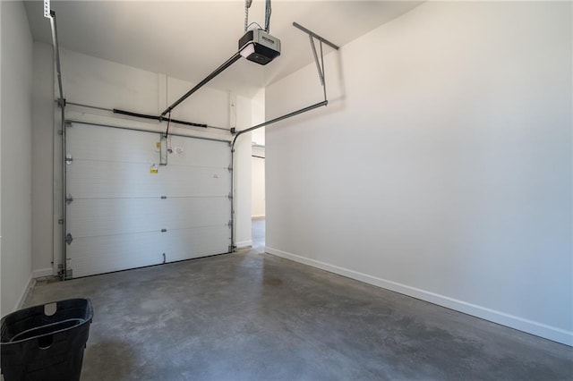 garage featuring a garage door opener and baseboards