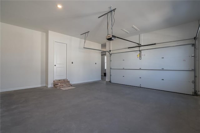 garage with a garage door opener and baseboards
