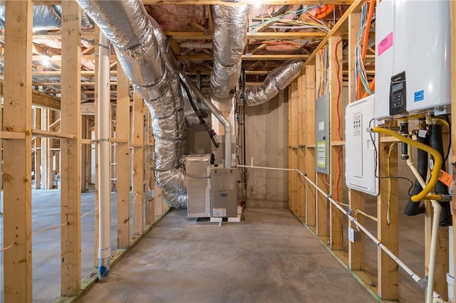 unfinished basement with electric panel, heating unit, and water heater