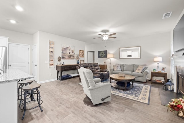 2046 Westbrook Rd, Commerce, GA 30530 - living room with ceiling fan, light wood-style flooring, a fireplace with flush hearth, baseboards, and recessed lighting