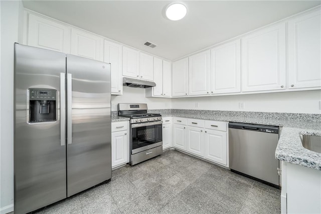 kitchen with light stone countertops, white cabinetry, and appliances with stainless steel finishes