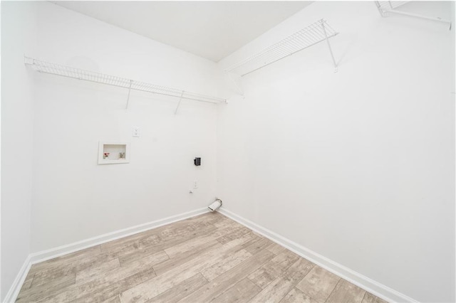 washroom featuring hookup for a washing machine, electric dryer hookup, and light hardwood / wood-style floors