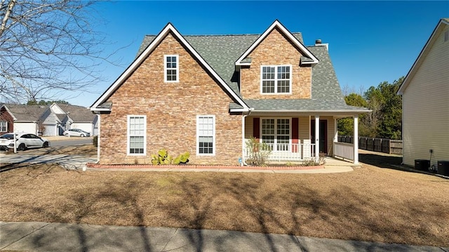 view of front of property featuring covered porch and a front lawn