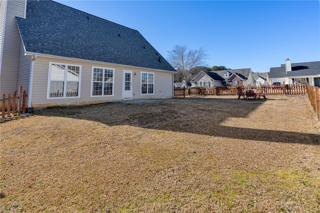 rear view of house with a lawn