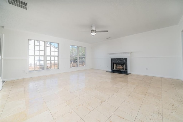 unfurnished living room featuring a fireplace and ceiling fan