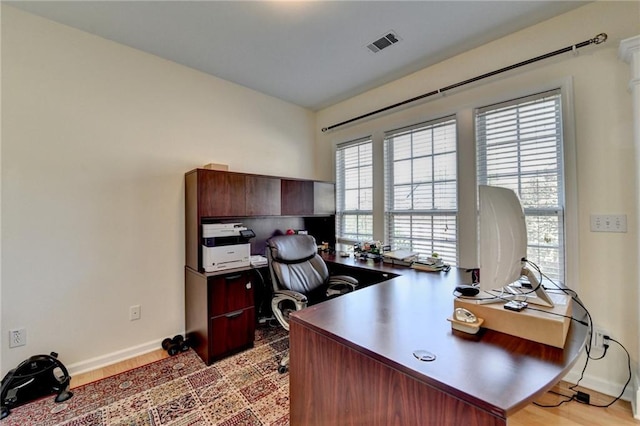 office featuring baseboards and light wood finished floors