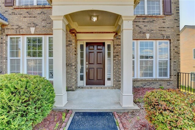 view of exterior entry with brick siding