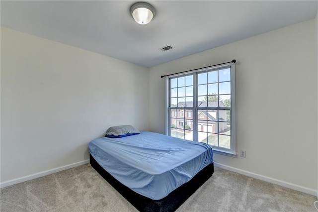 carpeted bedroom featuring baseboards