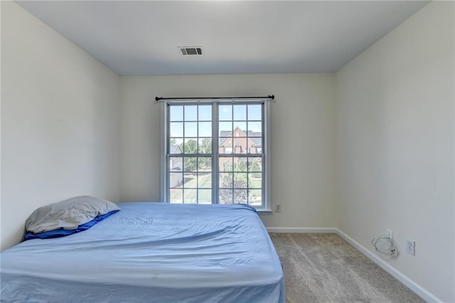 bedroom featuring carpet floors and baseboards