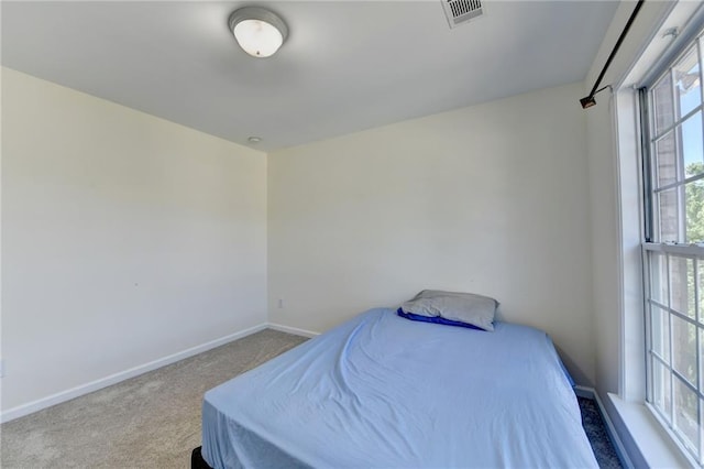 bedroom with carpet and baseboards
