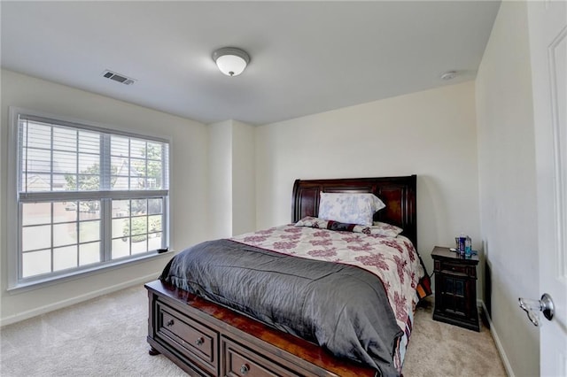 bedroom featuring light carpet and baseboards