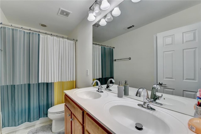 bathroom featuring double vanity, toilet, and a shower with curtain