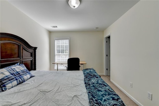 bedroom featuring light colored carpet and baseboards