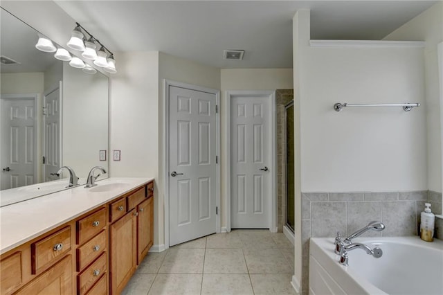 full bath featuring vanity, a stall shower, tile patterned floors, and a garden tub