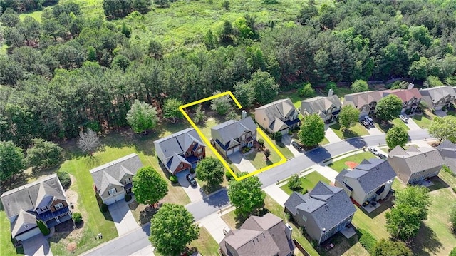 aerial perspective of suburban area featuring property parcel outlined and a forest