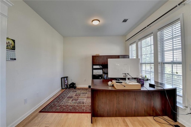 office area featuring light wood-type flooring and baseboards