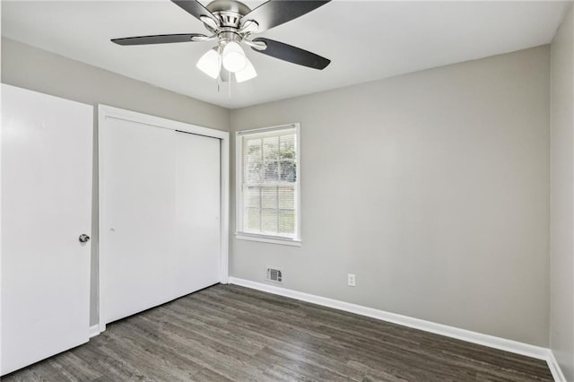 unfurnished bedroom with a closet, hardwood / wood-style floors, and ceiling fan