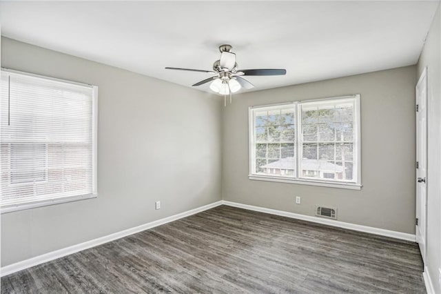 empty room with dark hardwood / wood-style flooring and ceiling fan