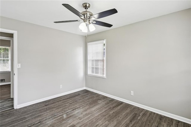 spare room with ceiling fan and dark wood-type flooring