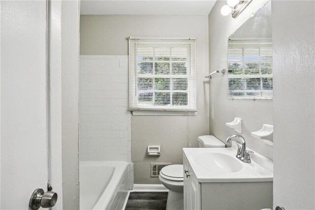 full bathroom with toilet, hardwood / wood-style floors, vanity, and a healthy amount of sunlight