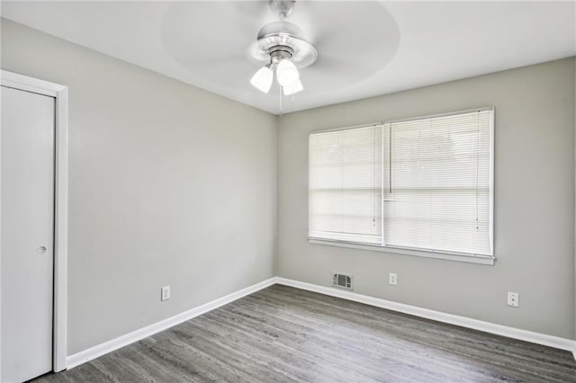 spare room with ceiling fan and hardwood / wood-style flooring