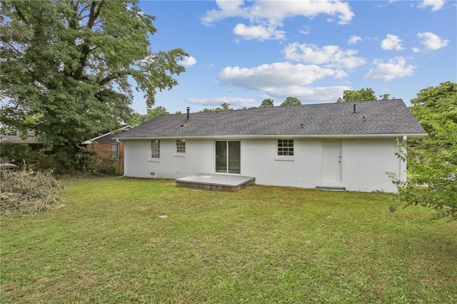 back of property featuring a patio and a yard