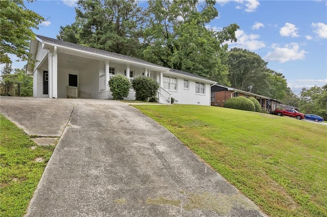 ranch-style home with a carport, driveway, and a front yard