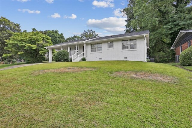 view of front facade with covered porch and a front lawn