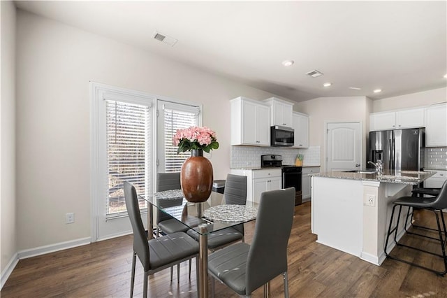 853 Bentley Dr, Fairburn, GA 30213 - dining area featuring plenty of natural light, dark wood-style floors, recessed lighting, and baseboards