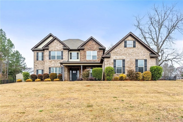 craftsman-style house with brick siding and a front yard