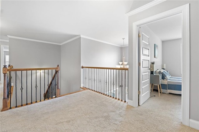 hall featuring an upstairs landing, baseboards, crown molding, and carpet