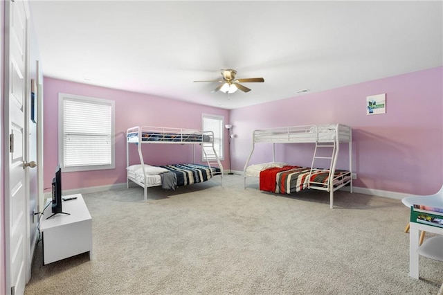 bedroom with baseboards and carpet