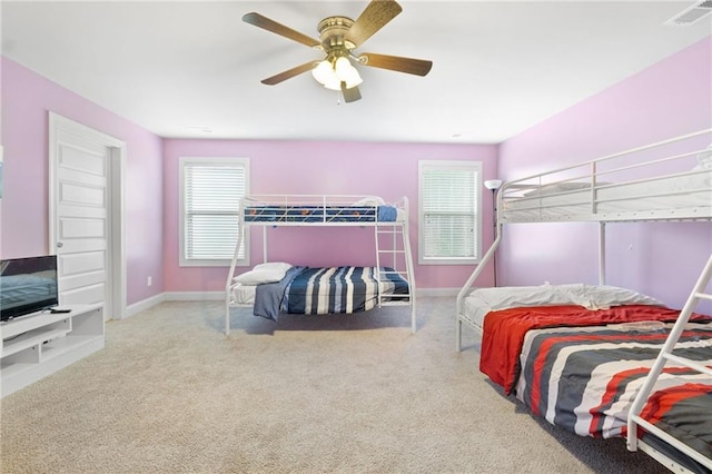 bedroom featuring visible vents, baseboards, ceiling fan, and carpet floors