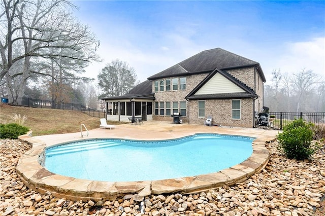 view of pool featuring a fenced in pool, a patio, a fenced backyard, and a sunroom