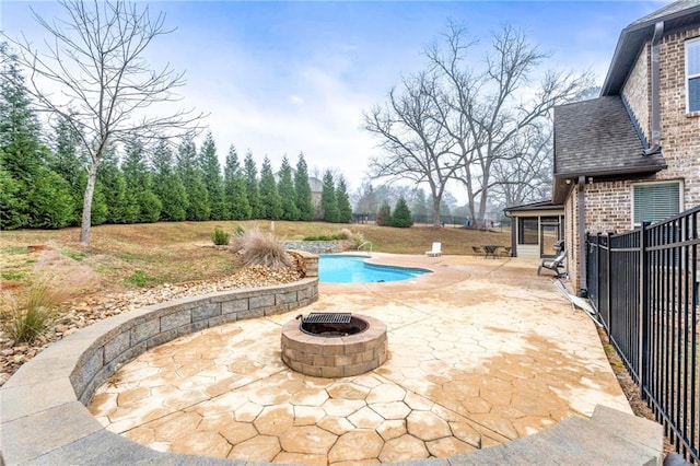 view of swimming pool featuring a fenced in pool, a fire pit, a patio, and fence