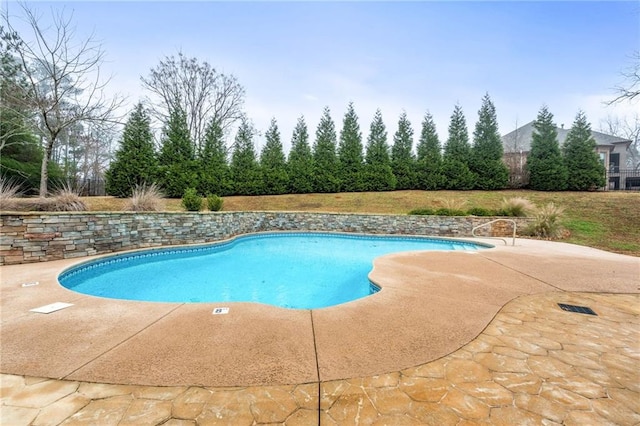 view of swimming pool featuring a patio area and a fenced in pool