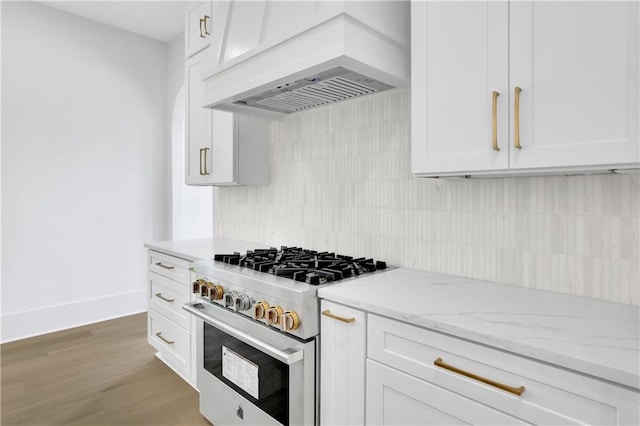 380 Hillcrest View Dr, Suwanee, GA 30024 - kitchen with high end stainless steel range, custom range hood, tasteful backsplash, white cabinetry, and light stone countertops