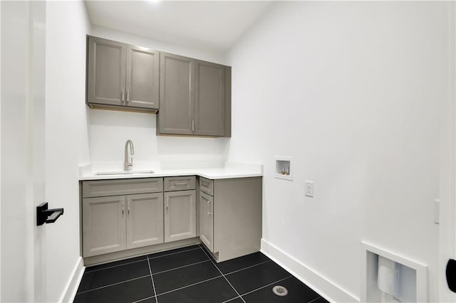 380 Hillcrest View Dr, Suwanee, GA 30024 - clothes washing area with baseboards, dark tile patterned flooring, washer hookup, and cabinet space
