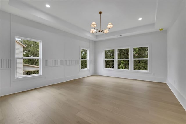 380 Hillcrest View Dr, Suwanee, GA 30024 - empty room featuring a raised ceiling, a chandelier, wood finished floors, and recessed lighting