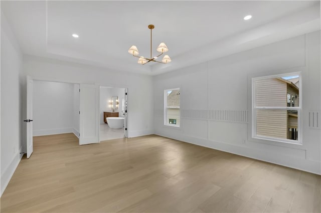 380 Hillcrest View Dr, Suwanee, GA 30024 - unfurnished room with a chandelier, light wood-style floors, recessed lighting, and baseboards