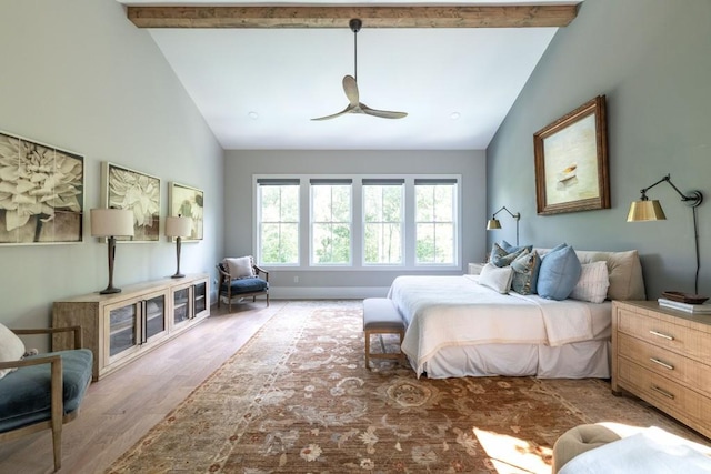 bedroom with lofted ceiling with beams, wood-type flooring, and ceiling fan