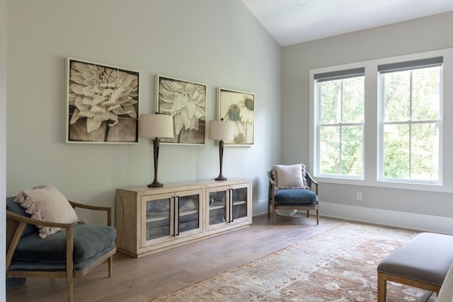 sitting room with lofted ceiling and hardwood / wood-style flooring