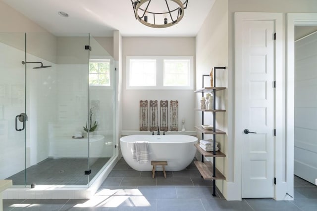 bathroom featuring tile patterned floors and separate shower and tub