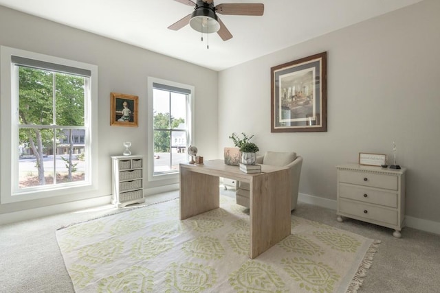 office space with light carpet and ceiling fan