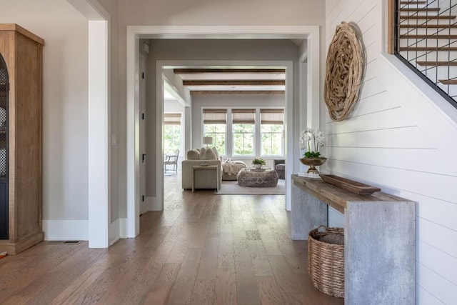 hallway featuring wood-type flooring and beamed ceiling