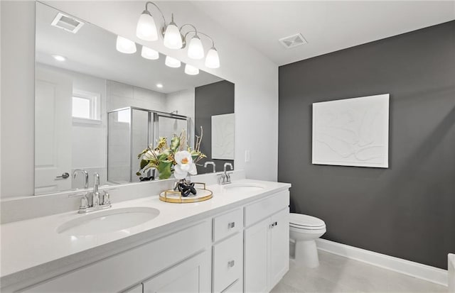 bathroom featuring tile patterned floors, toilet, a shower with door, and vanity