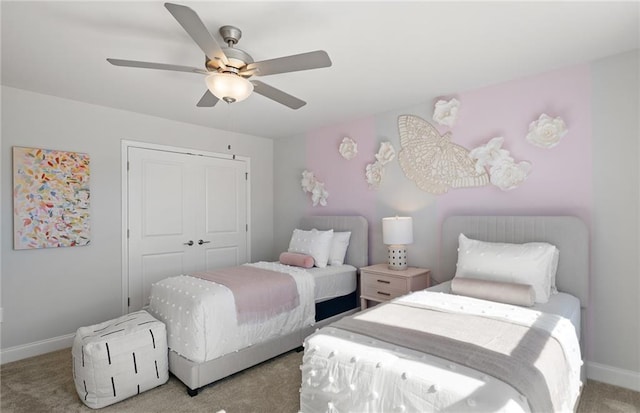 bedroom featuring ceiling fan, light colored carpet, and a closet