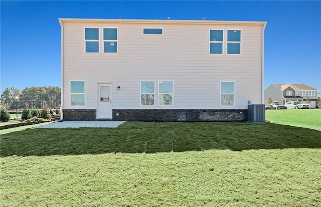 back of property with central AC unit and a lawn