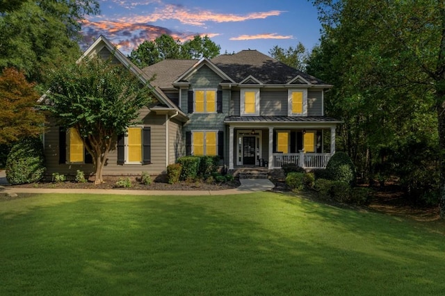 view of front of home with a porch and a front yard