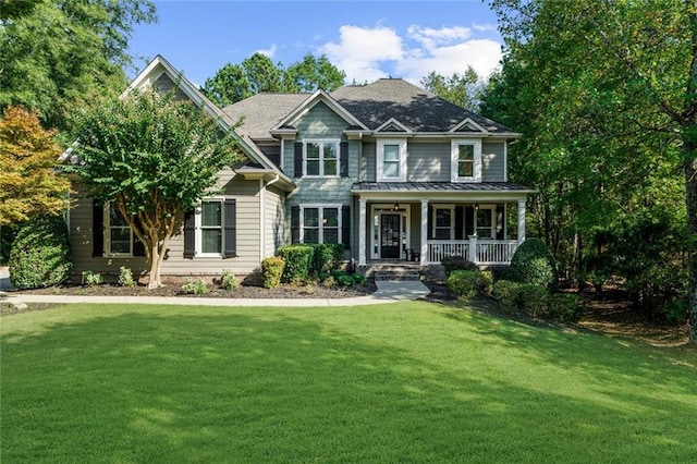 view of front of property featuring covered porch and a front lawn